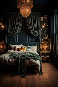 a bedroom with dark walls and wooden flooring is lit by a chandelier hanging from the ceiling