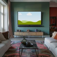 a living room filled with furniture and a flat screen tv mounted to the side of a wall