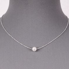 Floating Single White Pearl Dainty Silver Chain Necklace Delicate June Birthstone Pendant Simple Minimalist Jewelry This beautiful pearl and silver necklace is stunning! Simple and gorgeous, the look of this delicate silver chain accented by a single round 7 mm pearl is both classic and on trend. You can wear this pearl floating on dainty chain for any occasion. Also it`s wonderful necklace for Bride or Bridesmaids. Length: 16 inches with 3 inch extension Pearl: 6mm Closure: Lobster claw Weight: Pearl And Silver Necklace, Pearl Necklace Silver Chain, Minimalist Jewelry Silver, Silver Necklace Simple, Single Pearl Necklace, Single Pearl, Costume Fashion, Silver Pearl Necklace, Pearl Necklaces