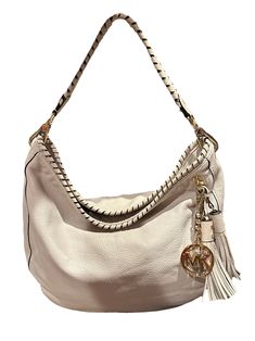 This function-with-style hobo handbag by KORS Michael Kors is crafted from off-white leather. The flat handle is wrapped in leather to match the wrapped opening. Gold tone hardware with logo zipper tabs and the MK dangling logo charm next to a fun duo of leather tassels.  The interior is lined with fabric and features three slip pockets. Condition  One tassel shows a minor mark. See last photo Beige Leather Hobo Bag With Handle Drop, Luxury Cream Soft Leather Hobo Bag, Cream Leather Shoulder Bag With Metal Hardware, Designer White Hobo Bag For Shopping, Luxury White Hobo Bag With Leather Handles, Luxury Cream Hobo Bag With Handle Drop, Cream Hobo Shoulder Bag With Handle Drop, White Leather Hobo Bag With Zipper Closure, White Leather Hobo Bag For Shopping