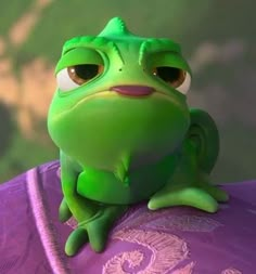 a green frog sitting on top of a purple object