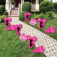 pink cheerleader yard decorations in front of a house