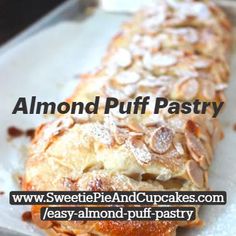 a pastry is sitting on top of a baking sheet with powdered sugar and almonds