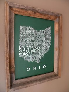 a wooden frame with a map of the state of ohio in white on a green background