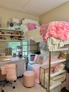 a loft bed with pink and white decor in a girls'bedroom, next to a desk