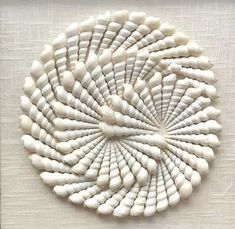 a white circular object made out of shells