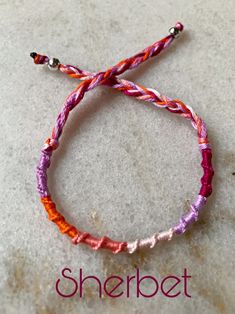 the bracelet is made with two different colored cords