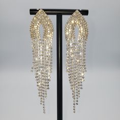 Sparkly Silver rhinestone, Marquise tip rhinestone top. With long rhinestone tassels at bottom 4 1/2" long Material: Zinc Alloy, Crystal, Rhinestone Hypoallergenic