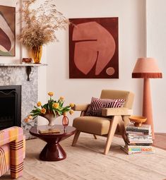 a living room filled with furniture and a fire place in front of a painting on the wall