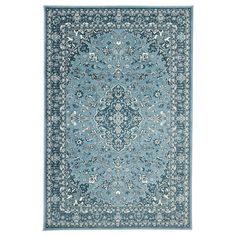 a blue rug with an ornate design on the center and bottom, in various colors