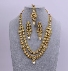 Featuring a gold-plated Meenakari necklace adorned with reverse AD and a maang tikka set, this versatile piece can be worn for any occasion. Style it with a neckline-flaunting dress or a saree to add sparkle to your overall look. Necklace can be adjusted with a doori. Jhumki Earring length: 2.5" with push-back closure Gold Polish on High-qality brass as the base metal Availability: In-Stock. *Color may vary slightly due to light condition & photography. Jewelry Care: Keep away from moisture. Allow perfumes and lotion to dry before wearing. Store in jewelry pouch. Clean only with soft lint free cloth. Maang Tikka Set, Meenakari Necklace, Contemporary Bracelets, Photography Jewelry, Kundan Necklace Set, American Diamond Necklaces, Double Layer Necklace, Contemporary Necklace, Contemporary Earrings