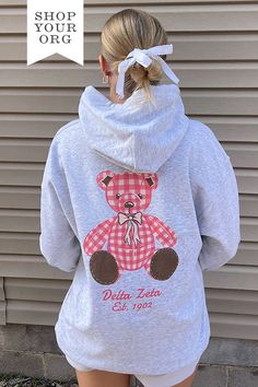 Available in 2XL - 3XL (Click Here) Product ColorAsh Product Details Gildan 18500 50/50 cotton/polyester Product Description Elevate your sorority wardrobe with our Plaid Teddy Sorority Hoodie. Crafted from the softest fabric, this hoodie provides ultimate comfort and style, making it a staple year round. Embrace the perfect blend of warmth and breathability with this must-have addition to your collection About the Design Featuring a trending design, our lightweight hoodie is adorned with an exc Kappa Delta Teddy Bear, Pink Sorority Letters Sweatshirt, Back Of Sweatshirt Designs, Sorority Hoodie Design, Sorority Christmas Shirts, Sorority Exec Sweatshirts, Sorority Parents Weekend Shirts, Delta Zeta Merch