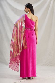 Hot pink draped saree in pleated satin with organza palla. Paired with one shoulder blouse and embroidered belt with tassels.
Component: 3
Pattern: Plain
Neckline: One Shoulder
Fabric: Pleated Satin, Organza
Color: Pink
Other Details: 
Textured saree
Tassel belt
Occasion: Destination Wedding - Aza Fashions Saree Tassel, Draped Saree, Saree And Blouse, Saree Tassels, Tassel Belt, Embroidered Belt, Drape Saree, Blouse For Women, Blouse Online