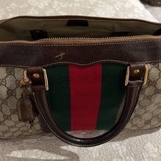 Vintage Gucci Duffle Bag With Lock And Key ! Authentic Purchased From Gucci Many Years Ago.Signs Of Wear But Still Lots Of Life. Authenticated By Posh! See Pics , Some Small Minor Water Stains Inside. This Is A Vintage Bag That Would Be The Condition. For Collectors. Smoke Free Pet Free Home. Measurements Of The Bag Are 14.5”L X 11”H X 6”W.... Vintage And Authentic See Posh Card Green Gucci Bag With Detachable Handle, Pre-owned Gucci Leather Bag, Pre-owned Rectangular Gucci Bag, Pre-owned Designer Satchel Bag, Designer Pre-owned Satchel Bag, Pre-owned Gucci Bags For Shopping, Designer Pre-owned Top Handle Bags, Pre-owned Gucci Top Handle Bag, Gucci Duffle Bag