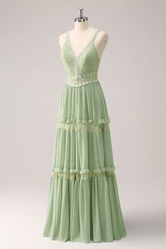 a green dress on a mannequin headdress with ruffles and lace