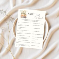 a white plate topped with a menu next to a plant