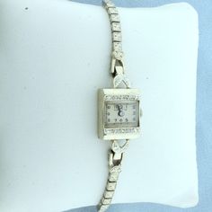 Band and Case in Solid 14K White Gold. Movement was rebuilt with quartz movement for high precision. Case is 17mm x 13.5mm. Contains ten high quality .01ct diamonds, VS clarity/H color. 6 3/4 inch long. Safety chain. 15.6g. Inventory 14985 Vintage Rectangular Diamond Watch With Diamond Hour Markers, Diamond Rectangular Watch For Anniversary, Safety Chain, Square Watch, Diamond Watch, Wrist Watches, Quartz Movement, Womens Watches, Wrist Watch