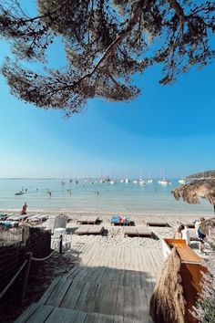 the beach is crowded with people and boats