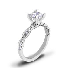 a white gold engagement ring with a princess cut center stone and side stones on the band