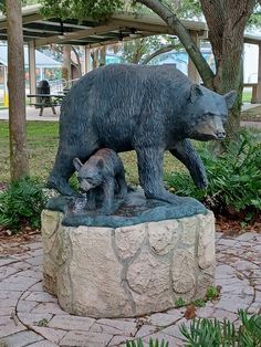 a statue of a mother bear and her cub