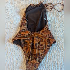 Gorgeous Earthtone Ikat Print, Plunge Back, Gathered Halter Top Neckline, Open Back One Piece Chic Swimsuit Brown One-piece Swimwear For Party, Fitted Brown Bodysuit For Beach, Fitted Brown Bodysuit For The Beach, Brown Backless Beachwear Swimwear, Chic Swimsuit, Top Neckline, Halter Swimsuit, Ikat Print, Swimsuits Halter