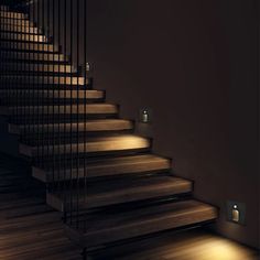 the stairs are lit up and there is no light on them in this dark room