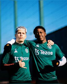 two soccer players are posing for the camera