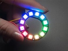 a person is holding a ring made out of leds