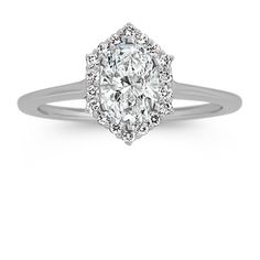 an oval cut diamond ring with halos on the shoulders