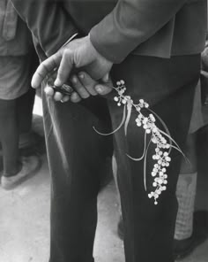 black and white photograph of person holding flowers