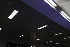 an empty room with several lights on the ceiling