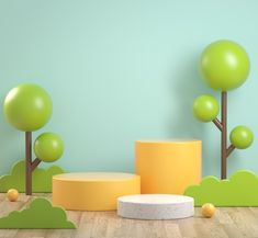 three green trees and some yellow balls on the floor