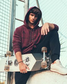 a man sitting on top of a white horse holding a skateboard