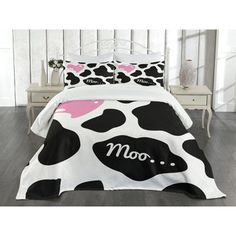 a black and white cow print comforter set with pink polka dots on the bottom