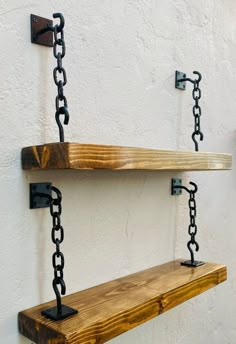 two wooden shelves with chains hanging from them