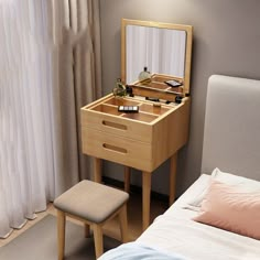 a small wooden dressing table with a mirror and stool in front of the bed, next to a window