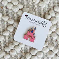 a pink castle pin sitting on top of a pile of white balls with black stars