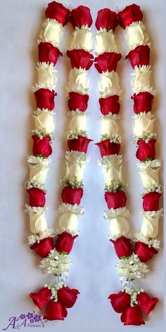 red and white flowers arranged in the shape of letters