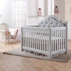 a baby's room with a crib and chair