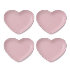 four pink heart shaped plates sitting next to each other