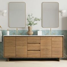 a bathroom vanity with two mirrors above it