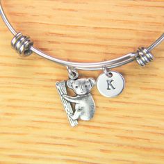 ♥ Koala Bear Charm Bangle Koala Bracelet Koala Charm Bracelet Koala Gift Animal Charm Personalized Initial Bangle Australia Bear Gift ♥ This is a silver-tone Koala Bear charm with hand stamped initial charm on an expandable bangle. ♥ You will receive 1 bangle ♥ Koala Charm 19.3x14,5x2 mm. ♥ Initial charm stainless steel 10mm choose from a drop-down menu. ♥ Bangle 57-64 mm ♥ additional initial https://www.etsy.com/listing/766732811 ♥ We strive for next day shipping, but we do not ship on Saturday Novelty Metal Charm Bracelet As Gift, Novelty Metal Charm Bracelet Gift, Adjustable Novelty Jewelry For Personalized Gifts, Adjustable Nickel-free Charm Bracelet As Gift, Adjustable Nickel-free Charm Bracelet Gift, Personalized Novelty Charm Bracelet, Silver Animal Design Jewelry For Gifts, Cute Adjustable Bangle Jewelry, Silver Jewelry With Animal Design For Gift