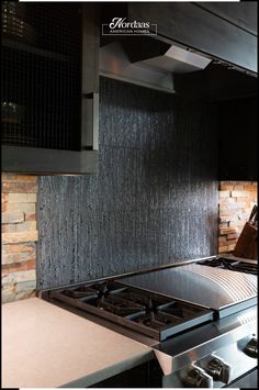 a stove top oven sitting inside of a kitchen next to a wall covered in water