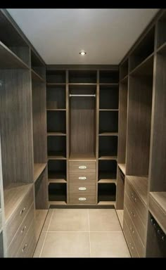 an empty walk in closet with lots of drawers