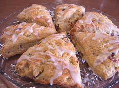 scones with icing sitting on top of a glass plate