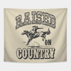 a sign that says raised on country with a cowboy riding a bucking bronco