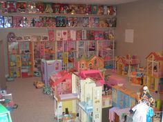 a room filled with lots of toys and doll houses on the walls, all in different shapes and sizes