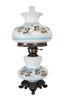 a white and blue lamp with flowers on it