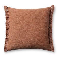 a brown pillow with fringes on the front and back of it, against a white background