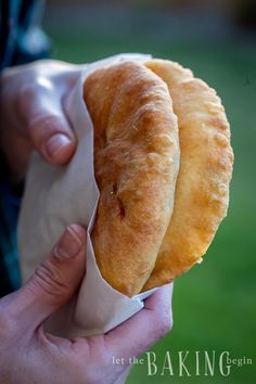 a person holding a pastry in their hand